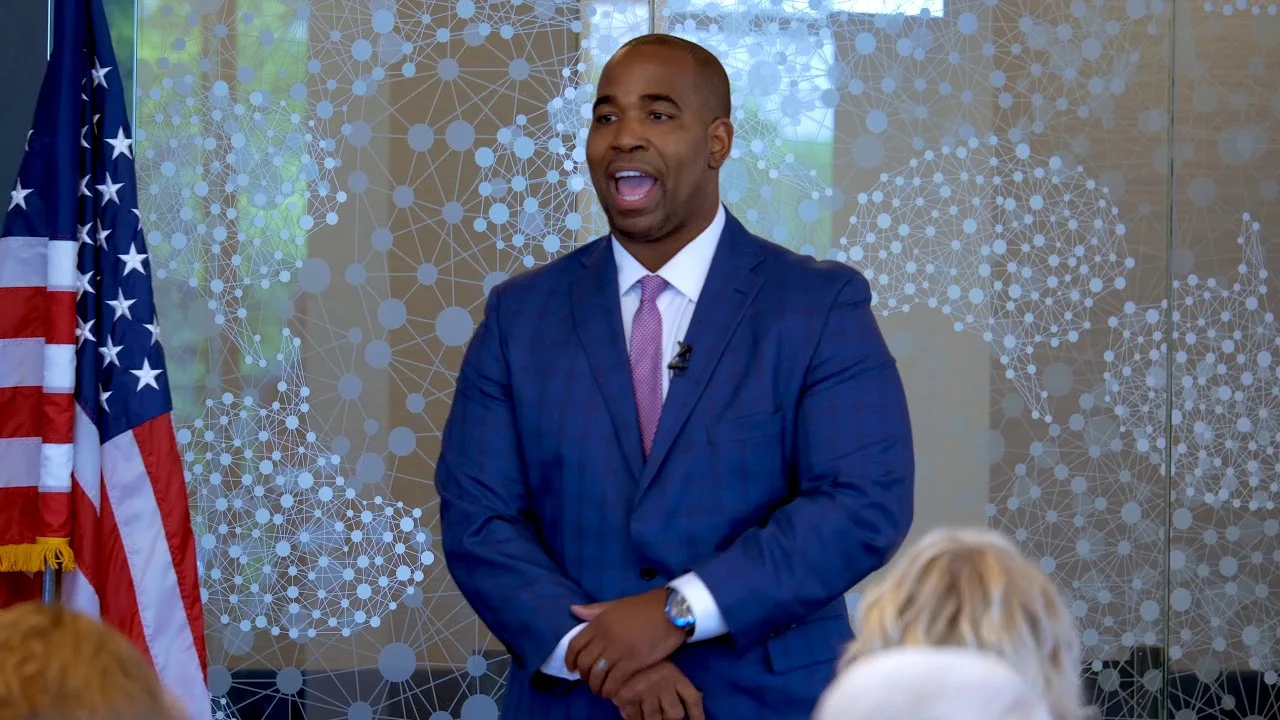 Marques Ogden speaking in a blue suit